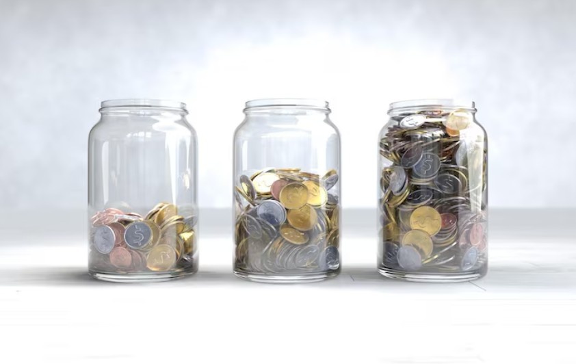 Emergency fund savings jar with coins, Personal Finance for Beginners